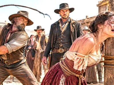 They Blamed the Widow for Her Late Husband’s Past and Tried to Break Her Spirit in Front of the Entire Town — But They Never Expected a Mysterious Gunslinger to Step Out of the Shadows. After Years of Silence, Fear, and Unfair Judgment, the Stranger Finally Drew the Line When He Saw an Innocent Woman Paying for Someone Else’s Mistakes. With a calm voice and a hidden past of his own, he stood between the widow and those who wanted to destroy her life. What happened next uncovered a forgotten secret, changed the town forever, and proved that justice can appear when no one expects it.